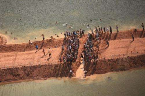 Activists dig a gap through a temporary earthen dam over the Xingu River in Para, northern Brazi
