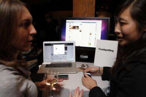 A Foodspotting representative demonstrates the company's app for Facebook