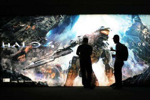 A gaming fan touches the advertising for Halo 4 at the Nintendo section on the E3 videogame conference in June 2012