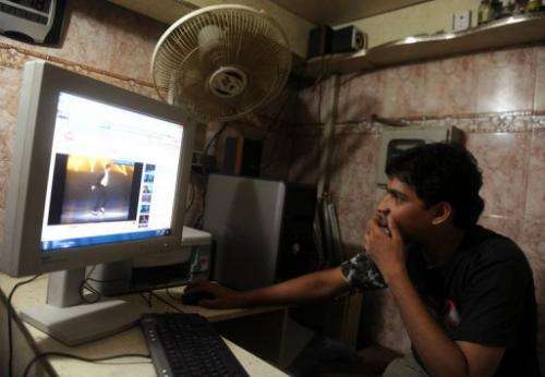 A Karachi resident is seen browsing video sharing website YouTube at an internet cafe, on May 27, 2010