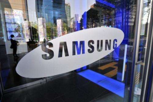 A logo of Samsung Electronics on the glass door of its showroom in Seoul on April 27, 2012
