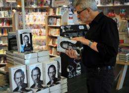 A man reads a biography of Apple co-founder Steve Jobs in 2011