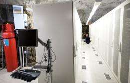 A man squats inside the Pionen high-security computer storage facility