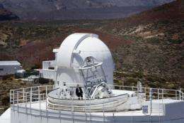 A man stands atop the German Solar Telescope GREGOR