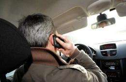 A man talks on a smartphone as he sits in a car in France, in January