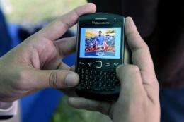 A man uses the new application for mobile phones of Venezuelan opposition candidate, Henrique Capriles Radonsk