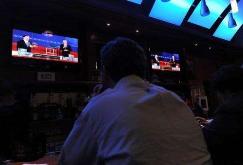 A man watches the second presidential debate