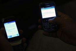 A mobile phone user accesses Facebook from cellular phones in Islamabad