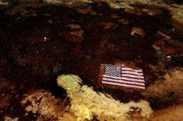 An American flag lays in a slick of oil that washed ashore from the Deepwater Horizon spill in 2010