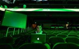 An attendee works on his computer after the Microsoft Xbox press conference