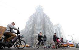 An office building stands out amid a hazy smog engulfing Beijing