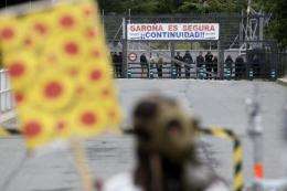 Anti-nuclear demonstrators protest in front of the Garona nuclear plant with a banner in 2011
