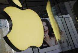 Apple's logo sign hangs in an Apple shop in Shanghai in April