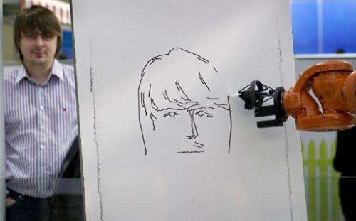 A robot draws a portrait of a visitor at the world's biggest high-tech fair, the CeBIT, in Hanover