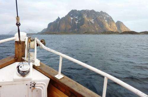 A tourist vessel plies the waters around Norway's Lofoten archipelago