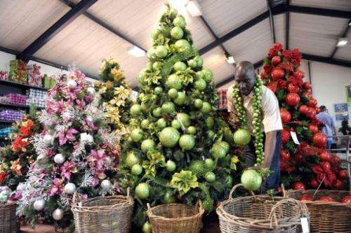 A vendor displays Christmas decorations on a christmas tree in a shop in Johannesburg