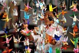 A woman hangs origami in Quezon City, east of Manila, in 2010