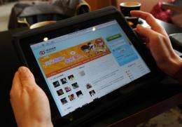 A woman views the Chinese social media website Weibo at a cafe in Beijing