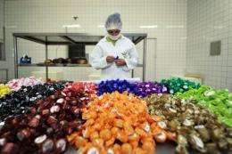 A worker inspects chocolates at a factory in Mecicilandia