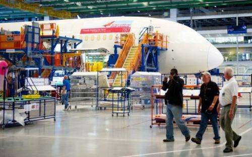 Boeing employees walk by one of Boeing 787 Dreamliners being built for Air India, in North Charlston, South Carolina