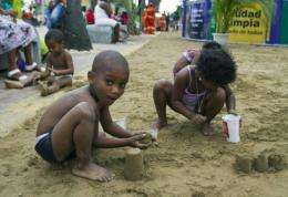 Children from a poor neighbourhood in Santo Domingo play with sand