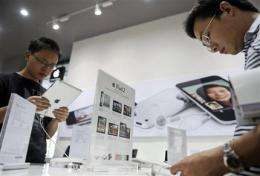 China faces conflict of law, business in iPad row (AP)