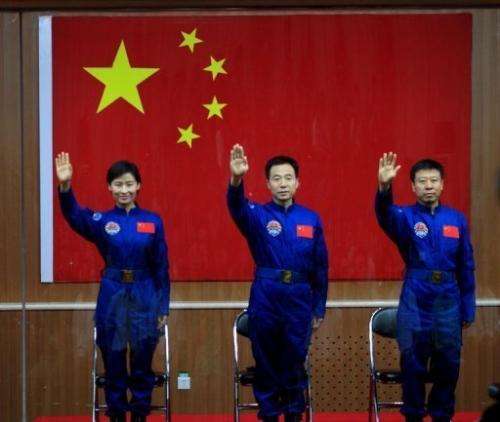Chinese first woman astronaut Liu Yang together with her two male colleagues, Jing Haipeng (centre) and Liu Wang