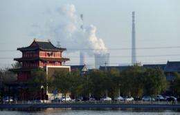 Cooling towers and smokestack chimneys of a coal-fired power plant are seen on the outskirts of Beijing