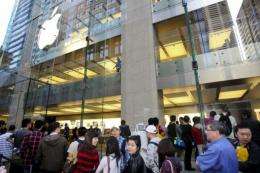 Customers line up outside an Apple store in Sydney