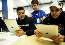 Customers look at the a new Apple iPad at Apple's store in New York