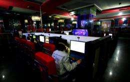 Customers use computers at an internet cafe in Hami, northwest China
