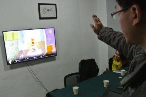 Developer tests a game for children in his office in Chengdu, southwest China's Sichuan province, on December 12, 2012