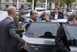 French President Francois Hollande waves as he leaves an environmental conference in Paris