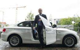 German Transport Minister Peter Ramsauer gets out of an E-drive BMW electric car as he arrives for a press conference