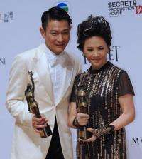 Hong Kong actors Deanie Ip (R) and Andy Lau on after winning awards for their roles in the film "A Simple Life"
