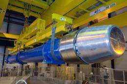 Image provided by CERN shows a large dipole magnet being installed into the Large Hadron Collider (LHC)