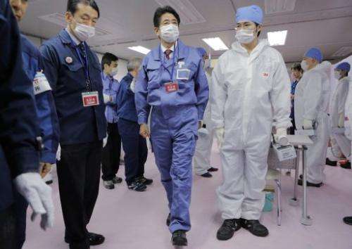 Japan's new PM Shinzo Abe (C) visits the crippled Fukushima Daiichi nuclear power plant in Ota, on December 29, 2012