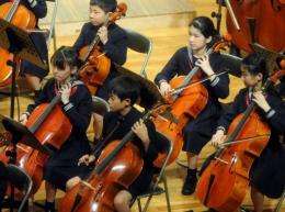 Japan's Princess Aiko (2nd R) plays the cello in the orchestra during the Gakushuin School Corporation's concert