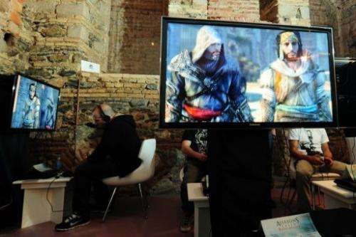 Journalist play a version of the "Assassin's Creed" videogame in Istanbul on September 29, 2011