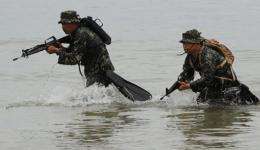 Members of Philippine marines reconaissance team run from the sea during a military exercise