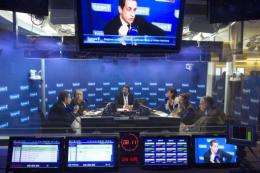 Nicolas Sarkozy (L) takes part in a radio show on the French radio station network Europe 1, in Paris
