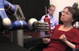 Paralyzed individuals use thought-controlled robotic arm to reach and grasp