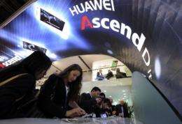 People check the Huawei Ascend P1S smartphone