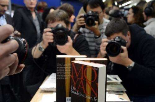 Photographers take pictures Chinese author Mo Yan's 2012 Nobel Literature Prize winning book