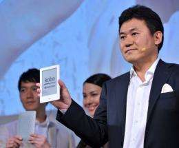 President of Japan's top online retailer Rakuten, Hiroshi Mikitani (R), introduces the "Kobo Touch"