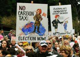 Protesters hold placards as they attend a no carbon tax rally in Sydney