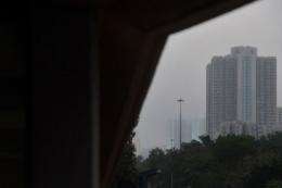 Residential building blocks are obscured by layers of smog in Hong Kong