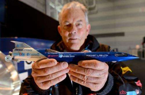 Rosco McGlashan holds a model of his rocket car that he and his team hope to use to break the land-speed record