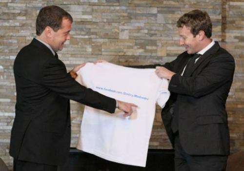Russian Prime Minister Dmitry Medvedev (left) receives a T-shirt as a present from Facebook CEO Mark Zuckerberg
