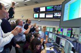 Scientists celebrating at the CERN's control center after the restart operation of the Large Hadron Collider in 2009
